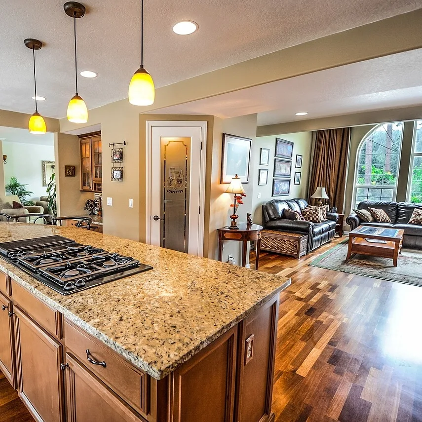 A kitchen with a large island and wooden floors