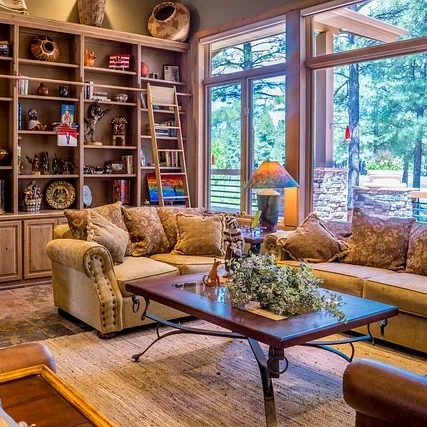 A living room with lots of windows and furniture.